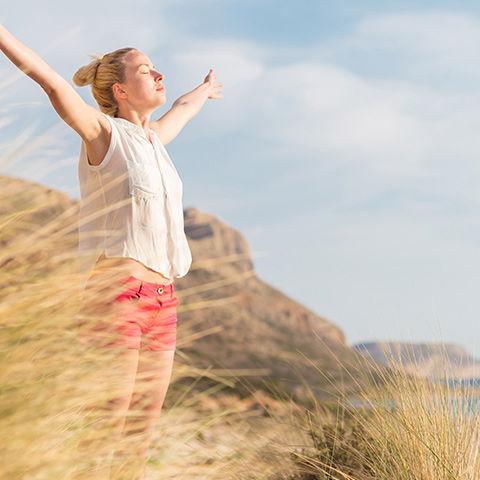 Frau tankt Vitamin D in der Sonne